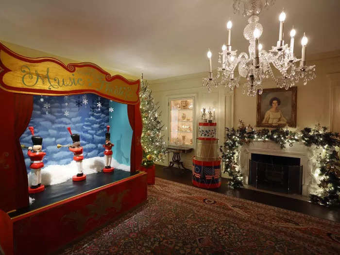 In the Vermeil Room, a tribute to holiday music and performance features a mechanical theater with United States Marine Band figures that spin and play herald trumpets.