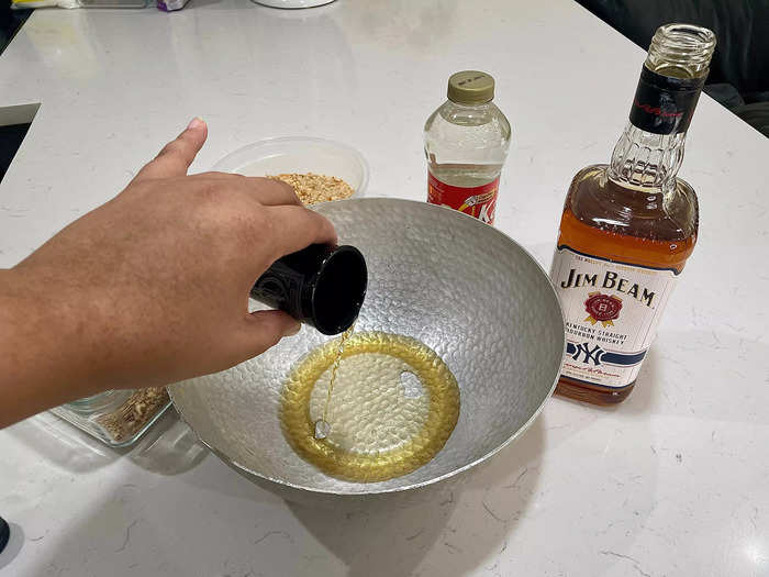 Pour three shots of whiskey into the bowl.