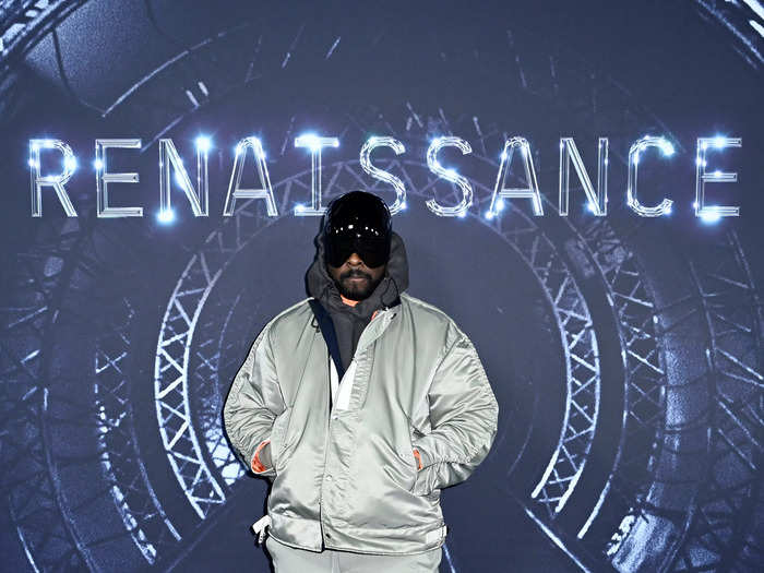 Rapper will.i.am kept warm with a chunky jacket, and a slick black helmet.