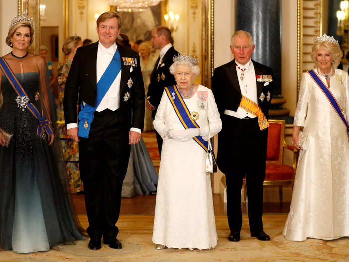 While visiting the British royals in 2019, Queen Máxima opted for a floor-length gown with a sheer neckline and sheer sleeves. She styled her hair in an updo and wore the Stuart Diamond Tiara. 