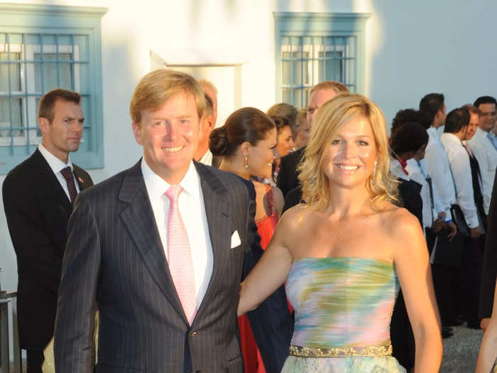 At a wedding in Greece in 2010, Máxima changed up her usual formal look with a green-and-pink strapless dress and a gold, sequinned belt.