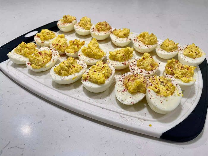 Use a small spoon to transfer the deviled egg filling back into the egg white half. 