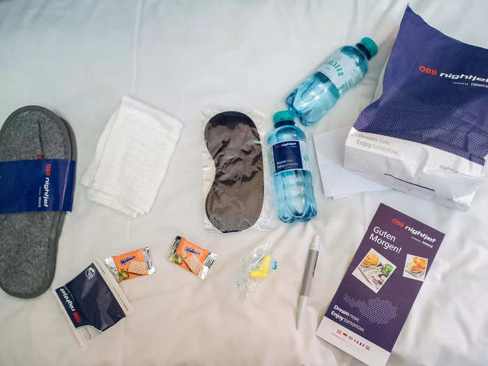 On the bed, there was a welcome bag with complimentary slippers, earplugs, and more.