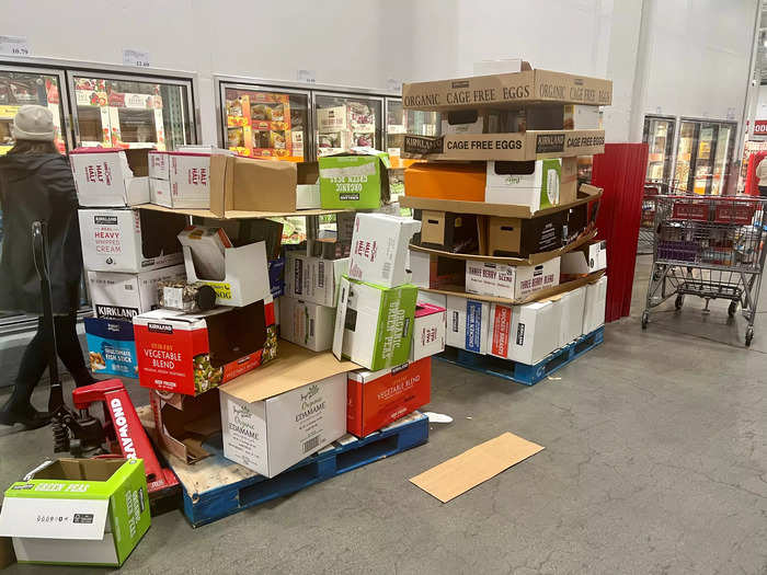 Costco employees are constantly moving empty packages to areas of the warehouse where shoppers can reuse them to store the items they buy. 