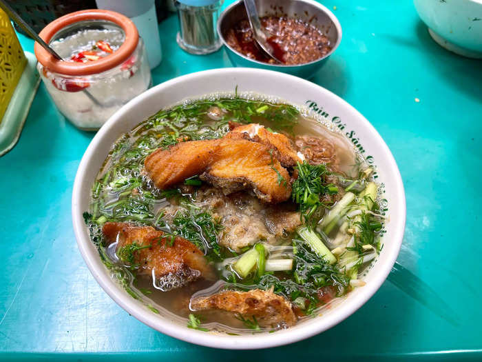 1.  Fish noodle soup in an alleyway next to a shrine