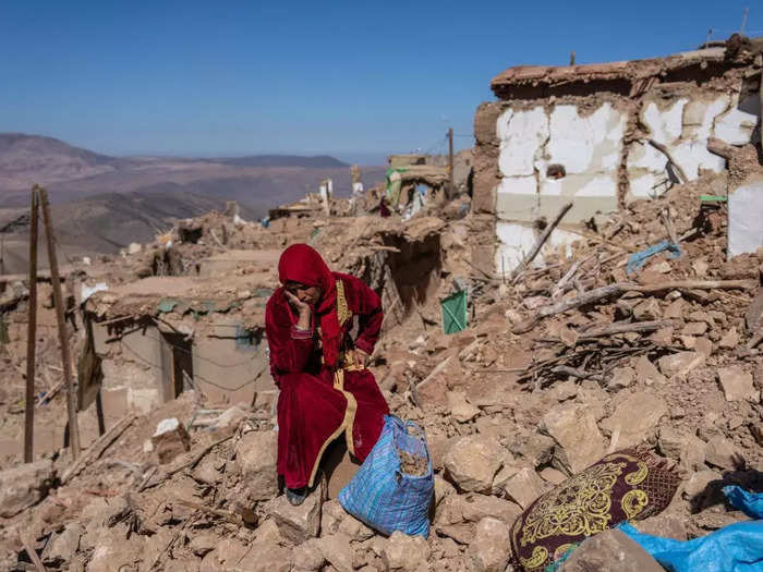 A woman sat among the rubble of her village in Douzrou, Morocco, which was damaged by an earthquake on September 8.