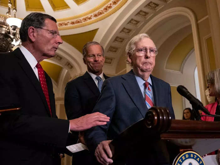 Sen. John Barrasso reached out to help Senate Minority Leader Mitch McConnell after McConnell froze and stopped talking during a news conference on July 26.