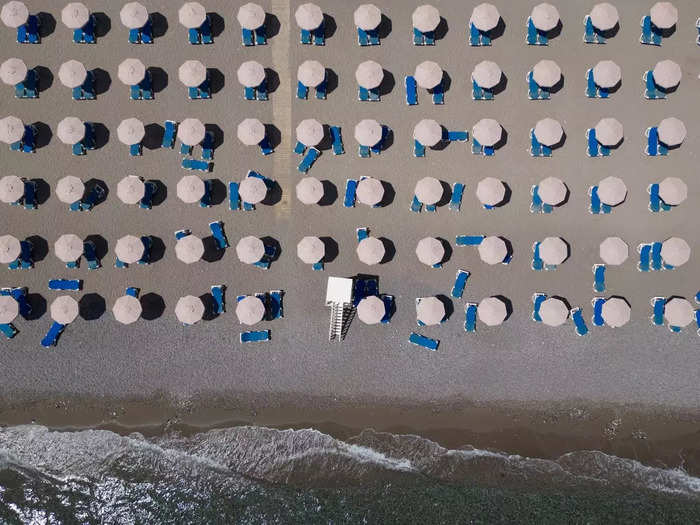 Empty sun loungers lined the beach at a resort in Lardos, Greece, on July 29.