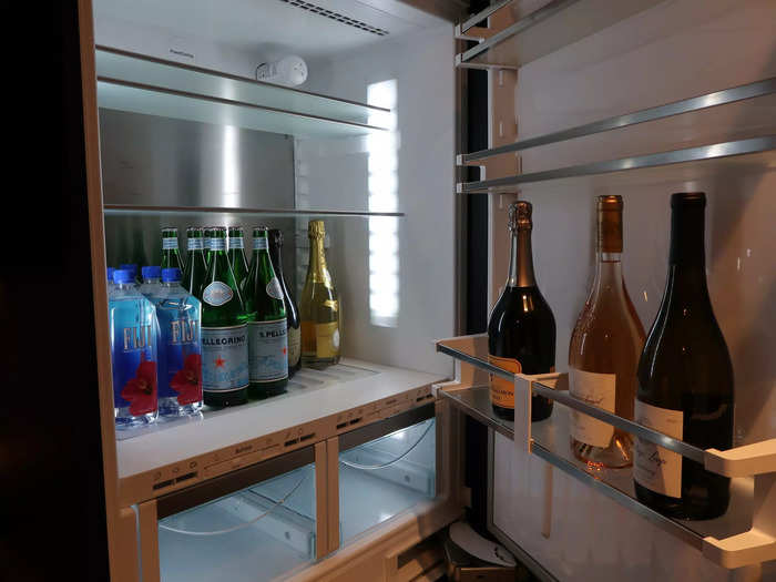 The penthouse boasted a large fridge, unlike the miniature versions often found in hotel rooms. This one was filled with champagne and wine.