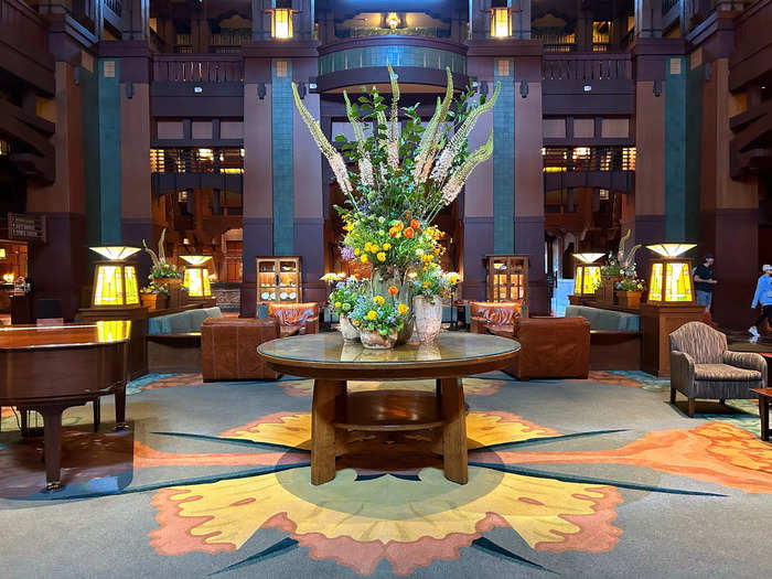 The lobby was stunning and featured a large fireplace, arching wood beams, and opulent floral arrangements.