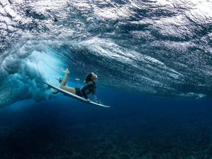 Australian surfer Olivia Ottaway dives under a wave in Teahupo