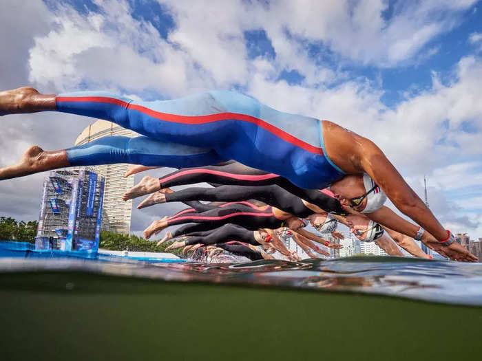 Swimmers dive into the water at Seaside Momochi Beach Park in Fukuoka, Japan, during an event at the World Aquatics Championships on July 15.