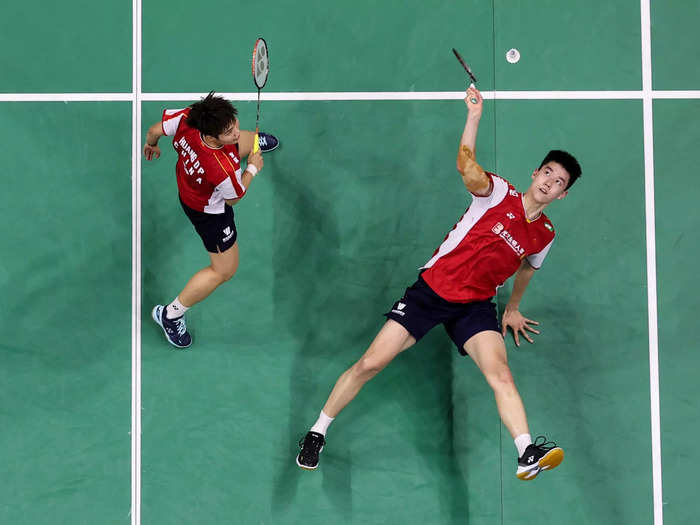 Feng Yanzhe (right) and Huang Dongping of China compete in a badminton mixed-doubles match against Japan on May 20.