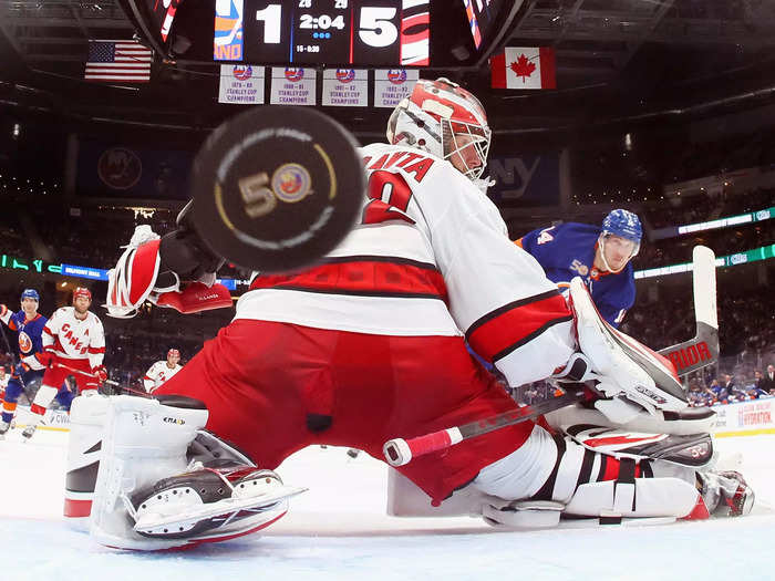 Bo Horvat of the New York Islanders scores against Carolina Hurricanes goalie Antti Raanta during the 2023 Stanley Cup Playoffs at UBS Arena on April 23. 