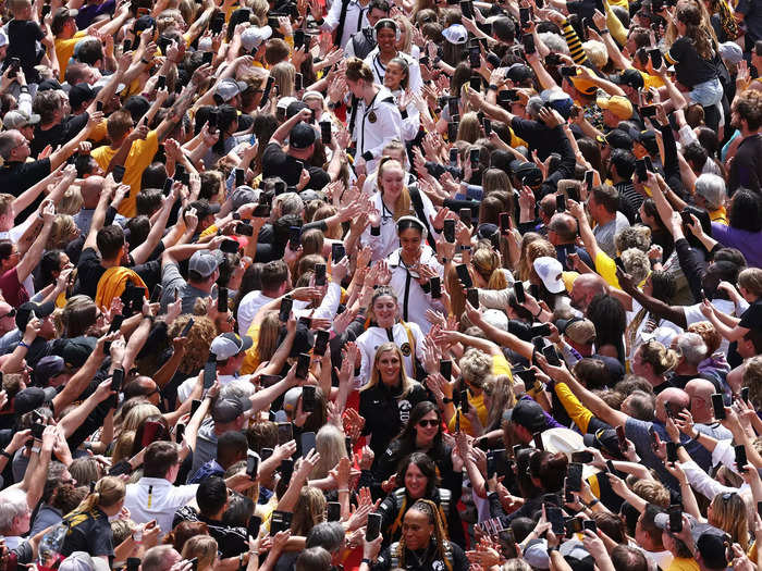 Iowa Hawkeyes players navigate a sea of fans prior to their 2023 NCAA Women