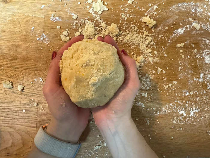 Transfer the mixture onto a floured countertop and gently work the pastry into a ball using your hands.