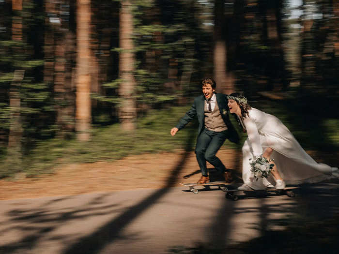 A bride and groom skateboard at their wedding in Latvia.