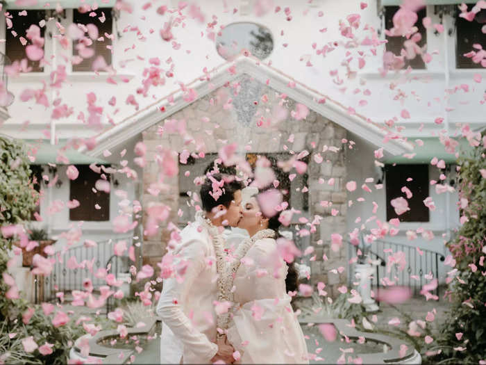 Falling cherry blossoms set the scene at a wedding in India.