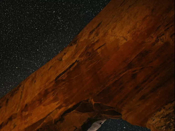 This bride and groom reach for the stars in Moab, Utah.