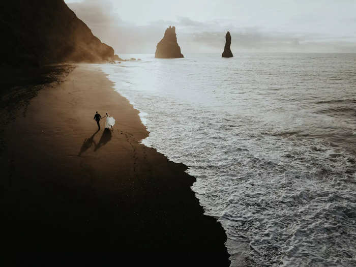 In this photo, another black-sand beach in Iceland provides a dramatic backdrop.