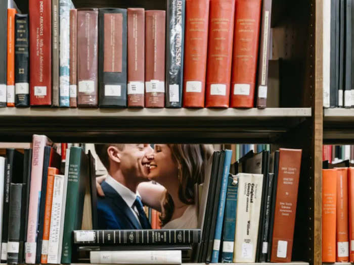 Any book-loving couple should seriously consider  taking their wedding photos in a library, like this couple in Birmingham, Alabama.