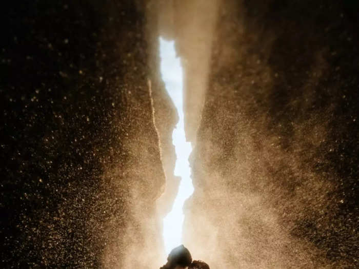 A couple shares an intimate moment at Gljufrabui waterfall on the south coast of Iceland.