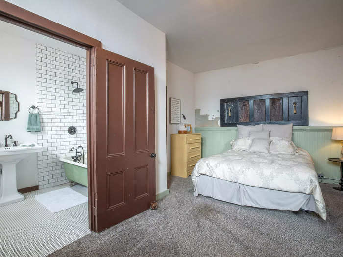 A bedroom with an ensuite bathroom is located on the first floor. 