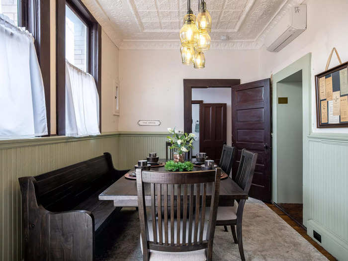 Behind the kitchen is a cozy dining room.