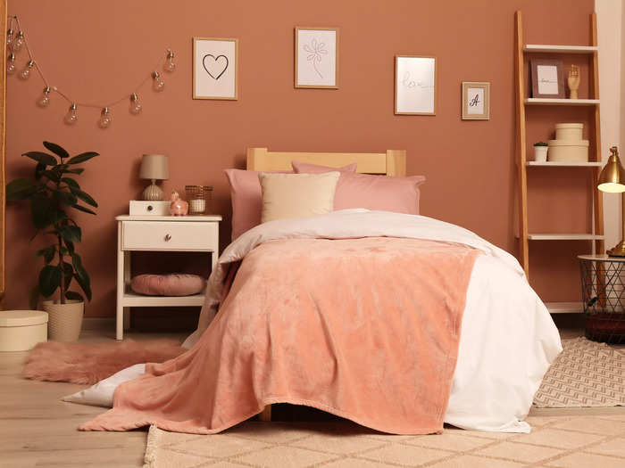 Soft coral adds a vibrant pop to the bedroom.