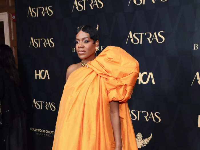 In January, Barrino wore a floor-length orange gown by Yousef Akbar. 