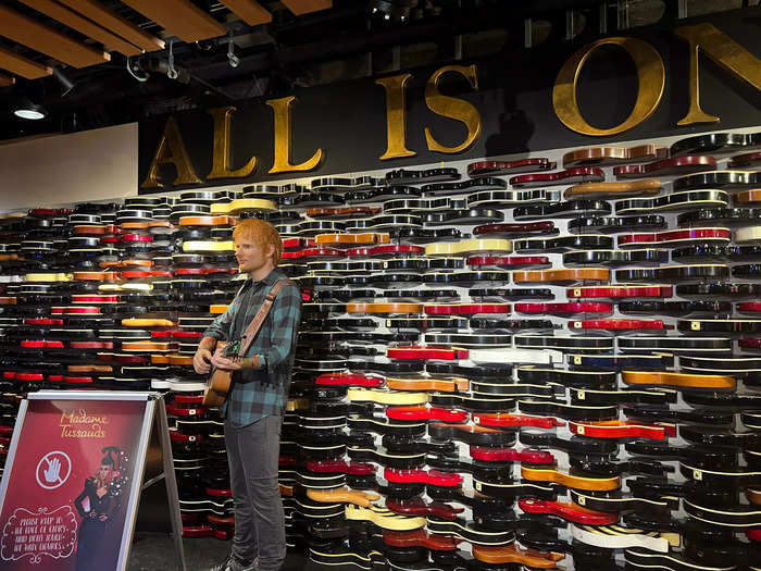 Around 30 minutes later, I was seated inside a different room — but first, I had to pass the iconic guitar wall.