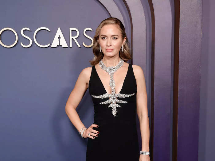 Emily Blunt wore a sparkling silver breastplate over a floor-length gown by Miu Miu.