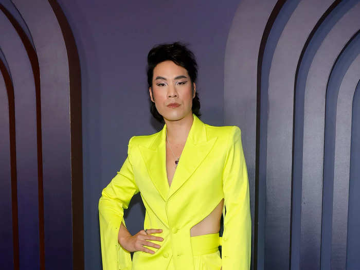 Eugene Lee Yang wore a daring neon suit with a side cutout and flared pants.