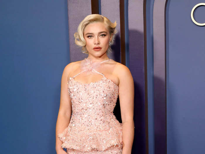 Florence Pugh wore a sequinned Rodarte dress with a flared waist and a halter neckline tied together with a floral bow. 