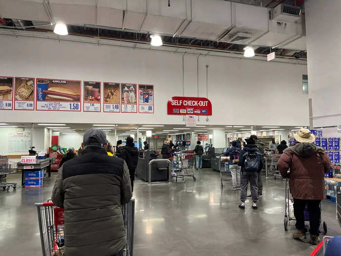 Both the cashier and self-checkout lines stretched out into the aisles with large numbers of people jostling for spots.