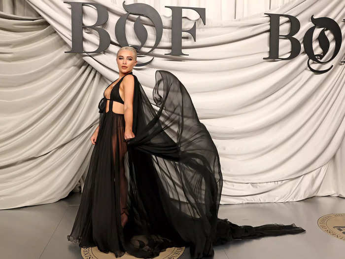 In the same month, Pugh wore a gothic black gown with a see-through skirt and striking cape to Paris Fashion Week. 