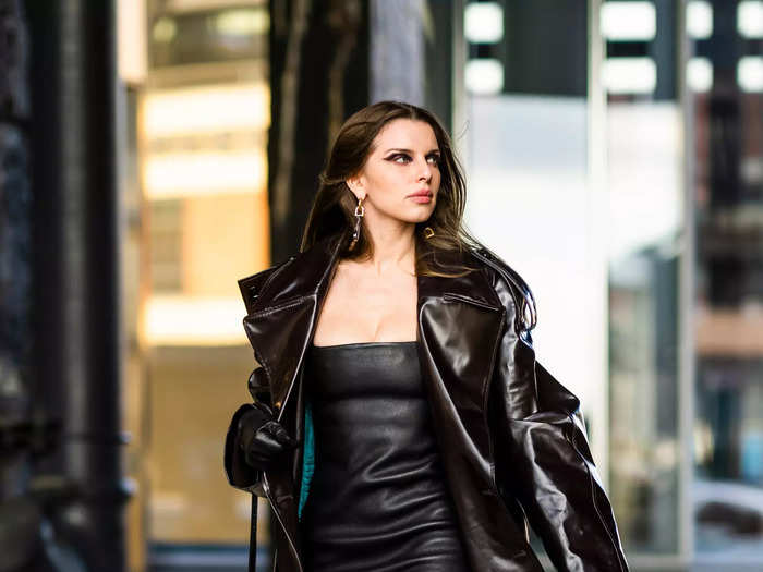 Also in February, Fox was seen wearing a black leather minidress, black thigh-high heeled boots, and an oversized black trench coat.