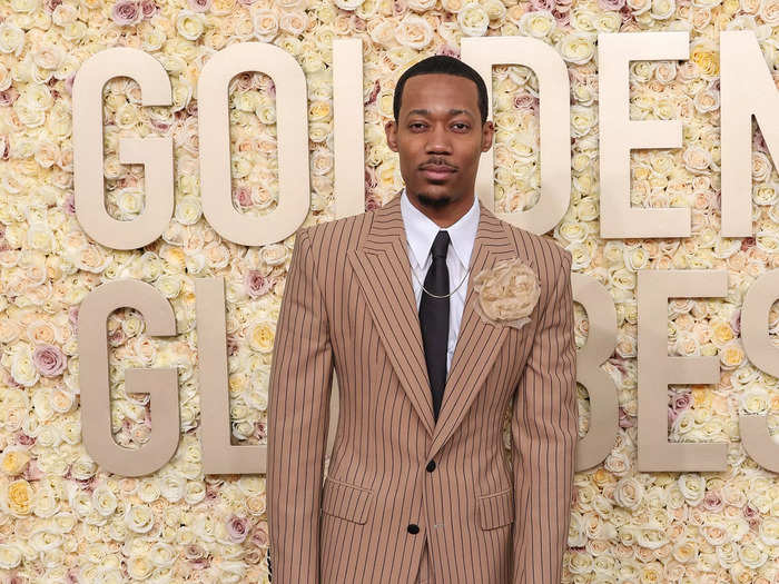 Tyler James Williams looked cool as can be in a pinstripe suit accessorized with a cream boutonniere at the Golden Globes.  