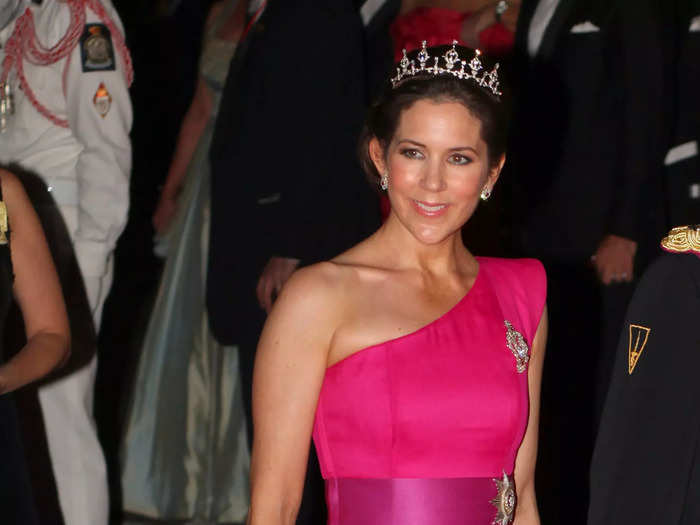 For one of her boldest looks to date, Mary wore a bright-pink, one-shoulder gown by David Anderson in 2011. She styled her hair in an updo with a tiara.