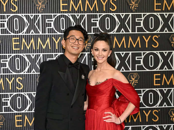 Lee Sung Jin chose a chic all-black suit, while Caitlin Solone Lee wore a red gown.  