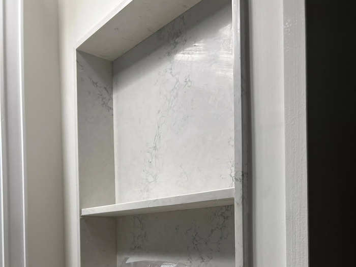 The mirror didn’t open, but there were built-in shelves next to the sink.