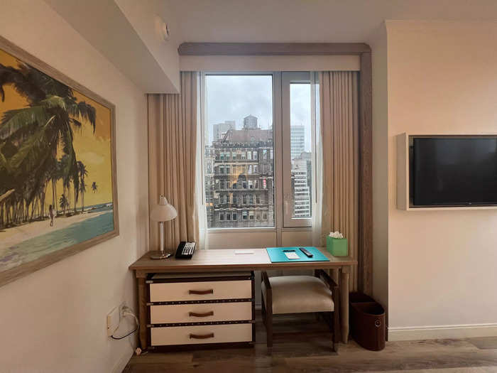 Across from the bed, I had a small desk with a set of drawers, a lamp, and a view of 7th Avenue.