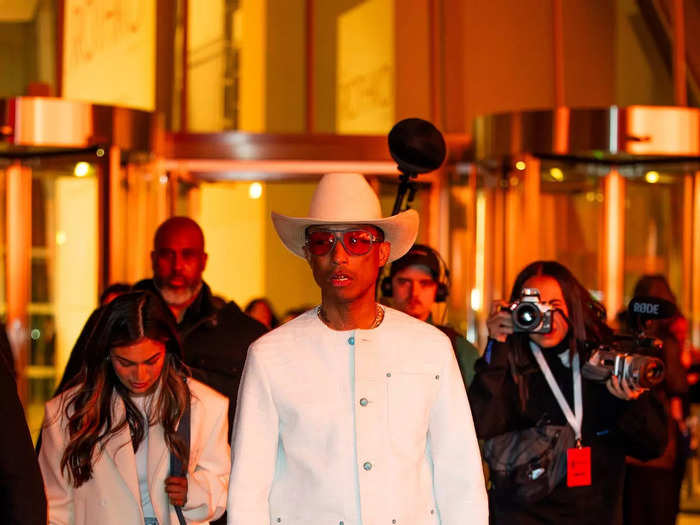 Pharrell Williams took to the streets of Paris in an elevated cowboy look ahead of debuting his western-themed Louis Vuitton menswear show. 