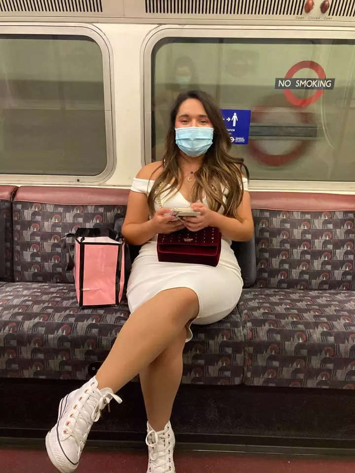 A woman on a London tube in a mask.