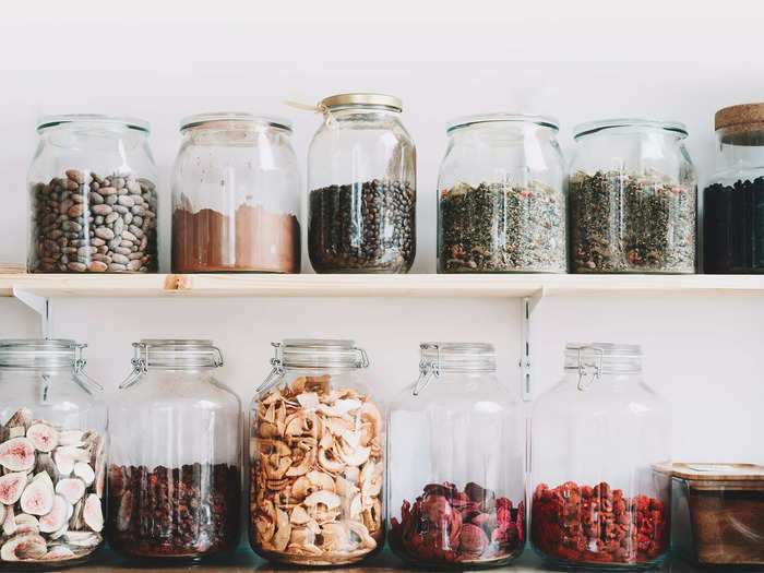 Increase kitchen cabinet space by putting groceries into matching storage jars.