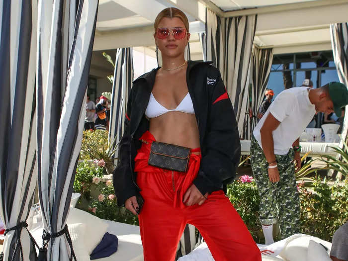 In 2017, Richie Grainge attended a Coachella party in baggy pants, a white bra, and a Reebok jacket.