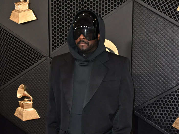 Will.i.am mixed his all-black outfit up with a helmet, hoodie, and suit jacket.