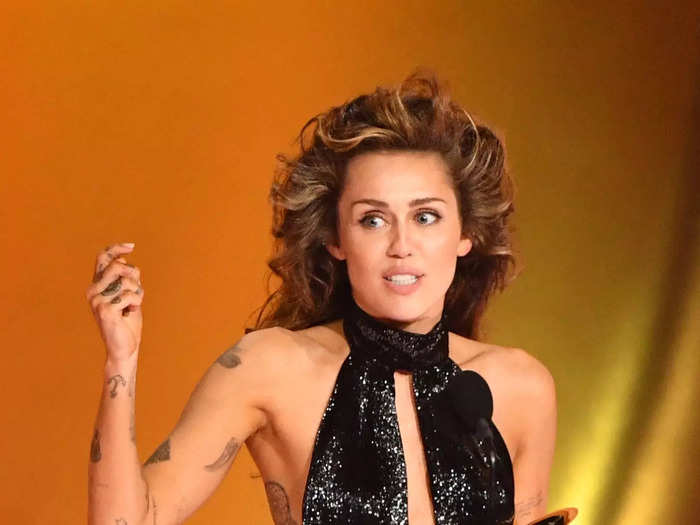 Miley Cyrus wore a glittery black bodysuit to accept the award for best solo pop performance.