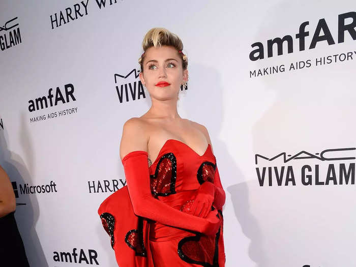 She then paired a strapless Moschino gown with red gloves and black boots.