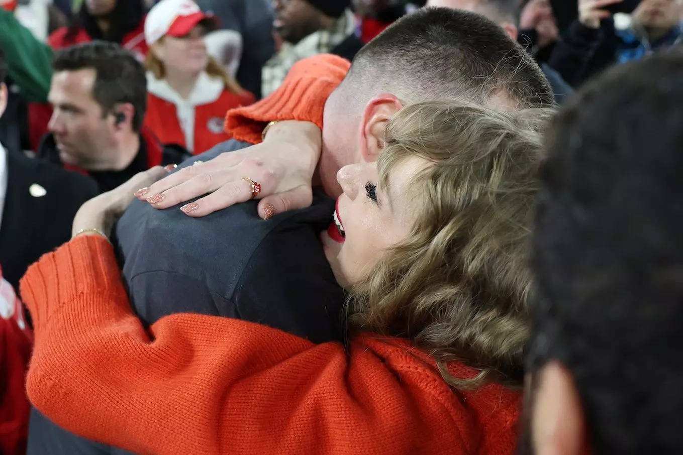 Taylor Swift hugs Travis Kelce while wearing an EB and Co. ring.